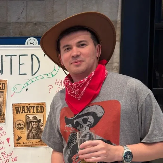 Sarvar Sultonov in a cowboy hat and red bandana